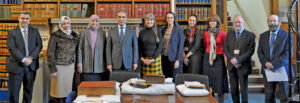 Group photo of all the guests and staff present at the event, taken in the Royal Courts of Justice library.
