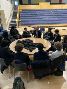 students and Judge Horton sitting around a round table having a discussion