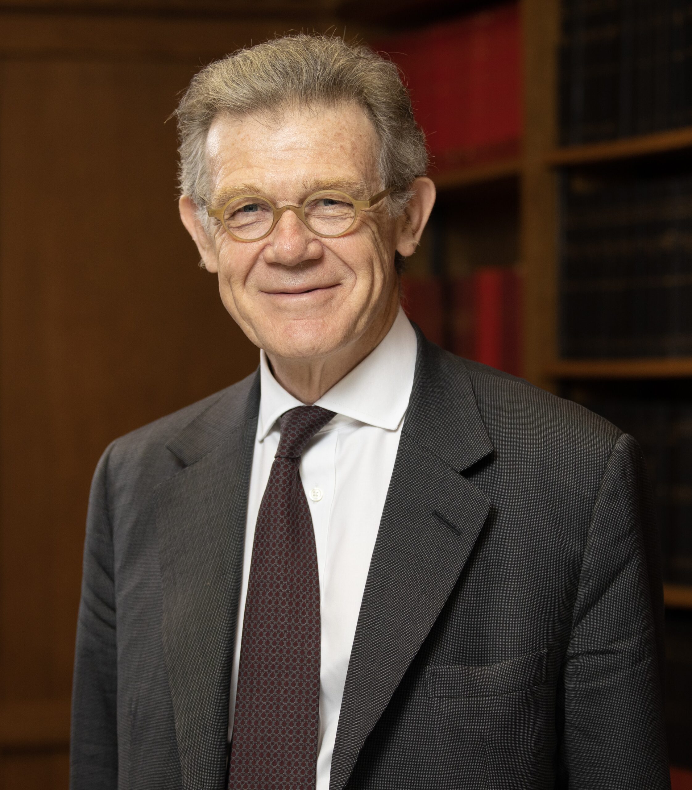 Portrait of the Rt Hon Sir Keith Lindblom. He is wearing a suit and smiling.
